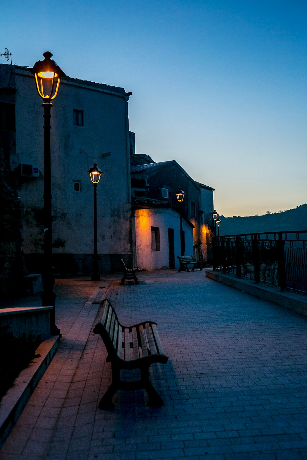 Cobblestone street in Ciudad Vieja Montevideo at dusk with warm street lamps