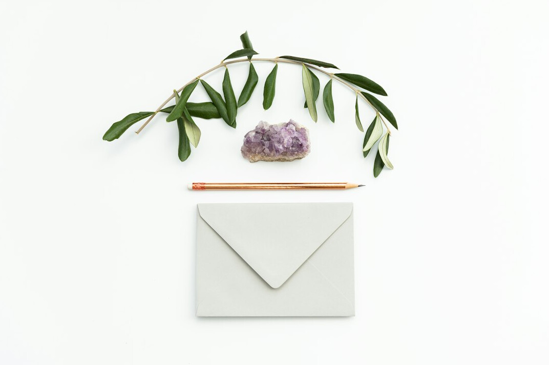 Handwritten letter with a fountain pen and an envelope on a wooden desk